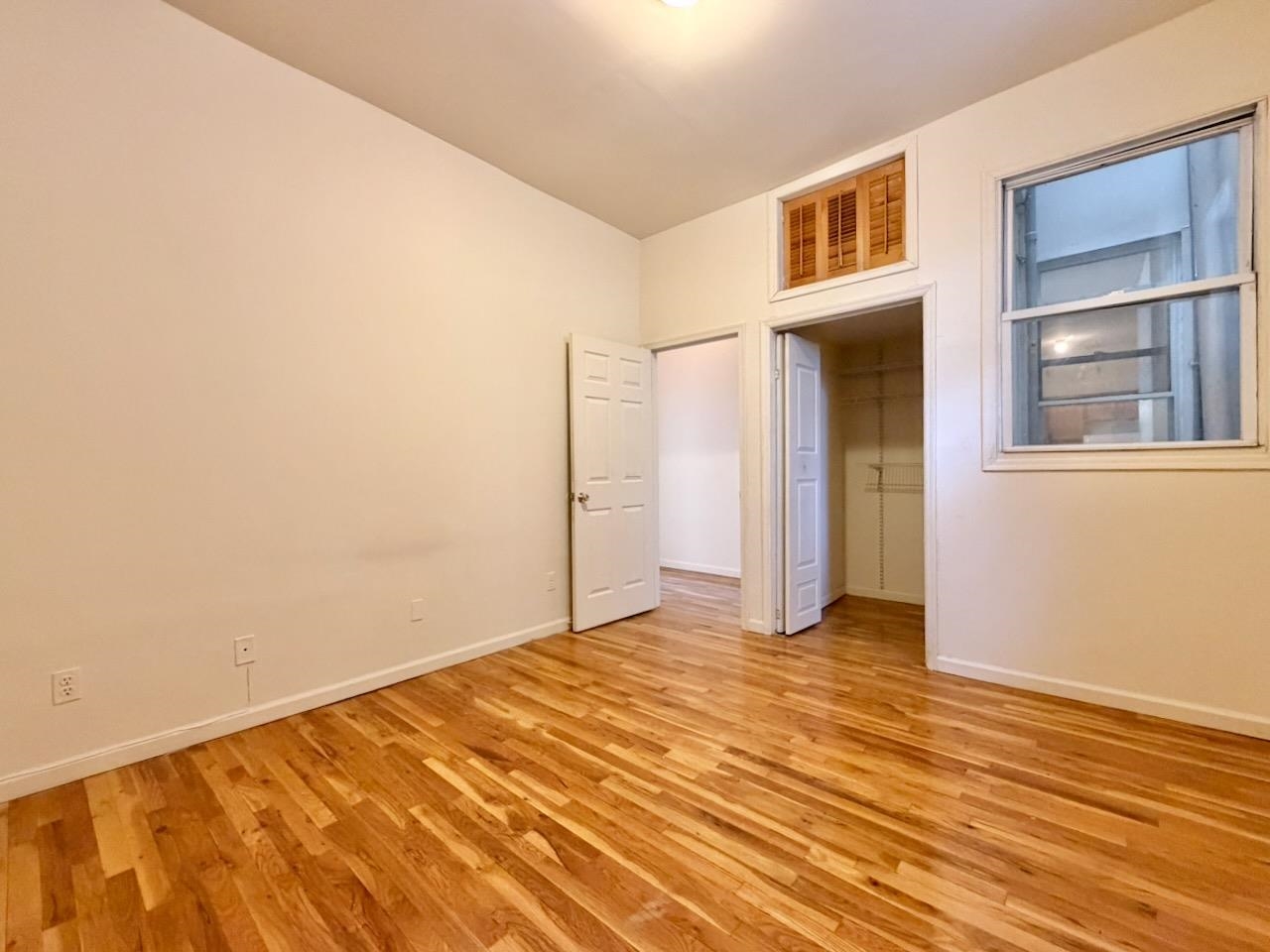 415 1st Street, Unit 2R Hoboken, NJ 07030 - Photo 14 of 22 a view of an empty room with wooden floor and a window