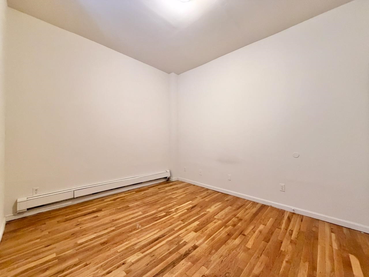 415 1st Street, Unit 2R Hoboken, NJ 07030 - Photo 15 of 22 a view of an empty room with wooden floor