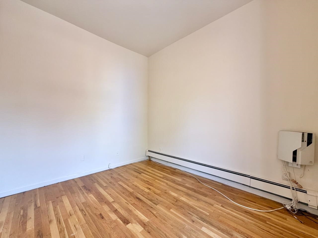 415 1st Street, Unit 2R Hoboken, NJ 07030 - Photo 17 of 22 a view of empty room with wooden floor
