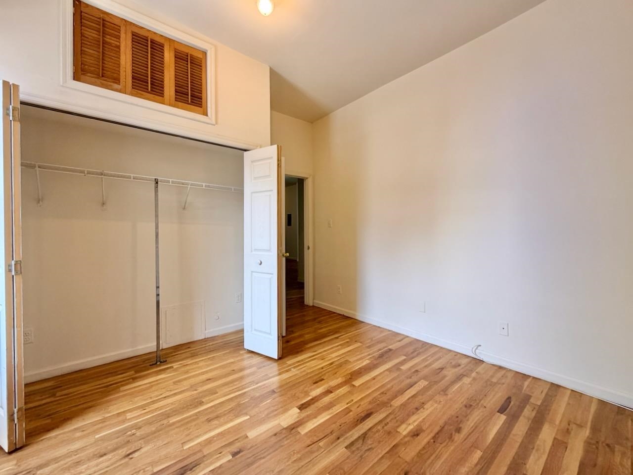 415 1st Street, Unit 2R Hoboken, NJ 07030 - Photo 18 of 22 a view of an empty room with wooden floor and a window
