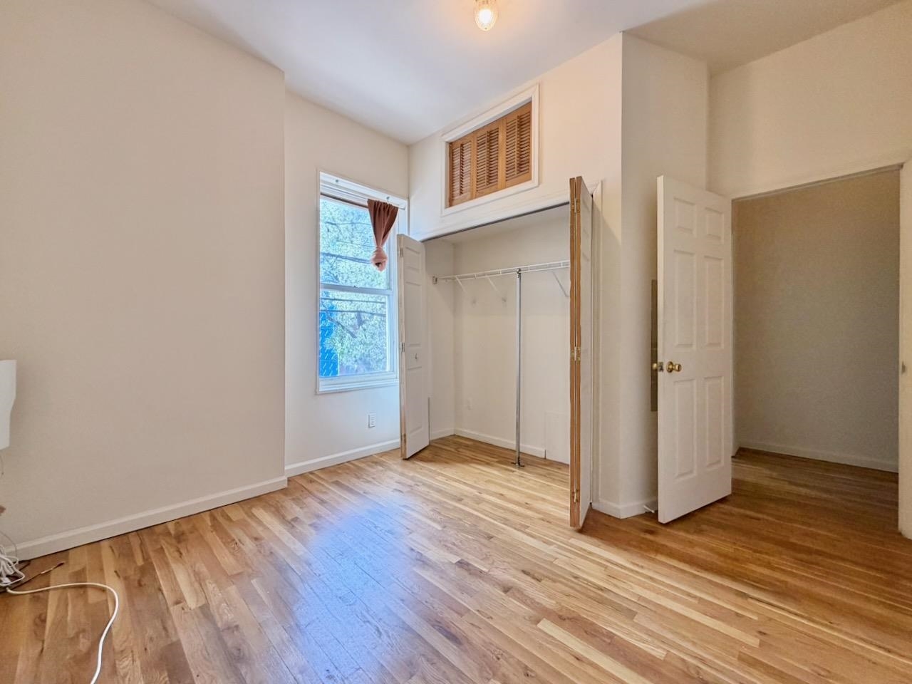 415 1st Street, Unit 2R Hoboken, NJ 07030 - Photo 19 of 22 an empty room with wooden floor and windows