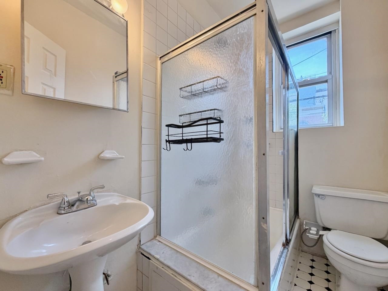 415 1st Street, Unit 2R Hoboken, NJ 07030 - Photo 20 of 22 a bathroom with a sink toilet and shower