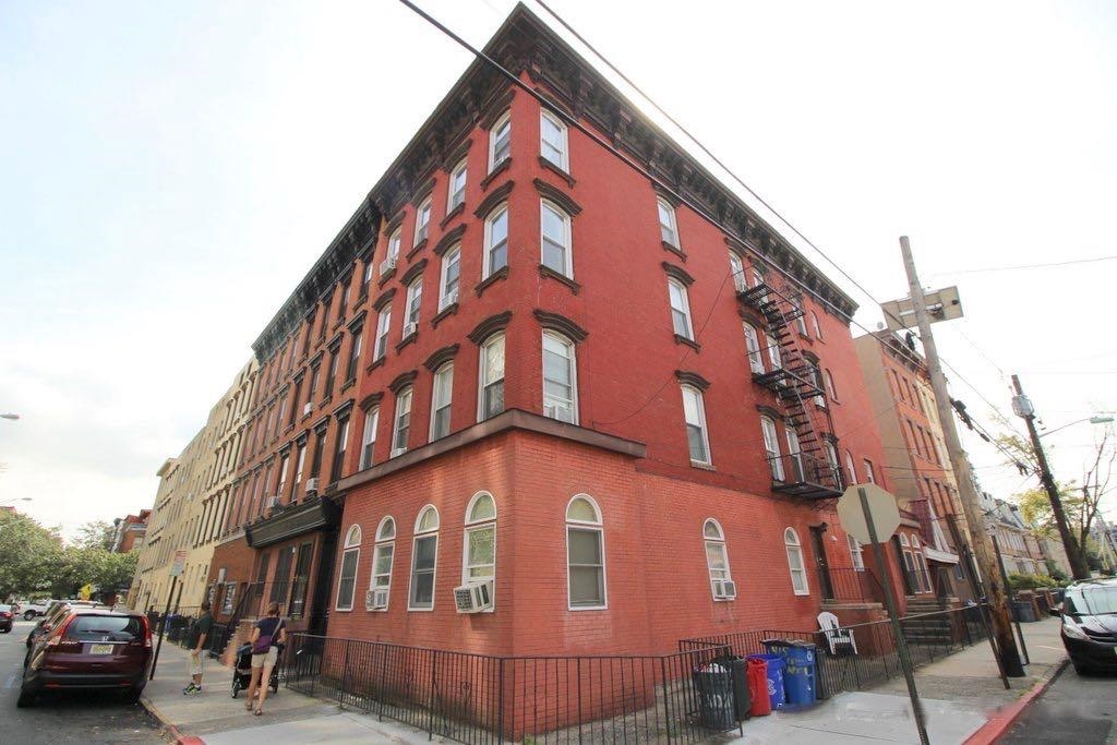 415 1st Street, Unit 2R Hoboken, NJ 07030 - Photo 22 of 22 a tall building sitting on the side of a street