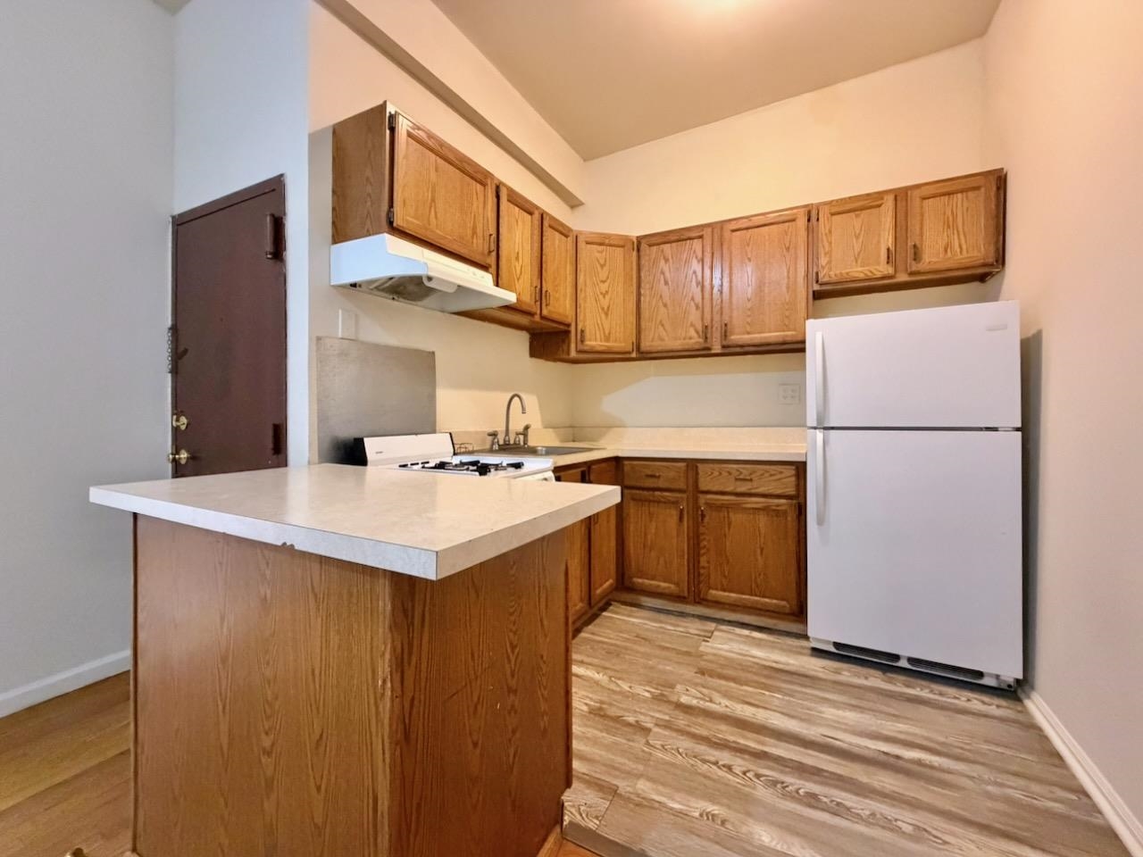 415 1st Street, Unit 2R Hoboken, NJ 07030 - Photo 5 of 22 a kitchen with a sink refrigerator and cabinets