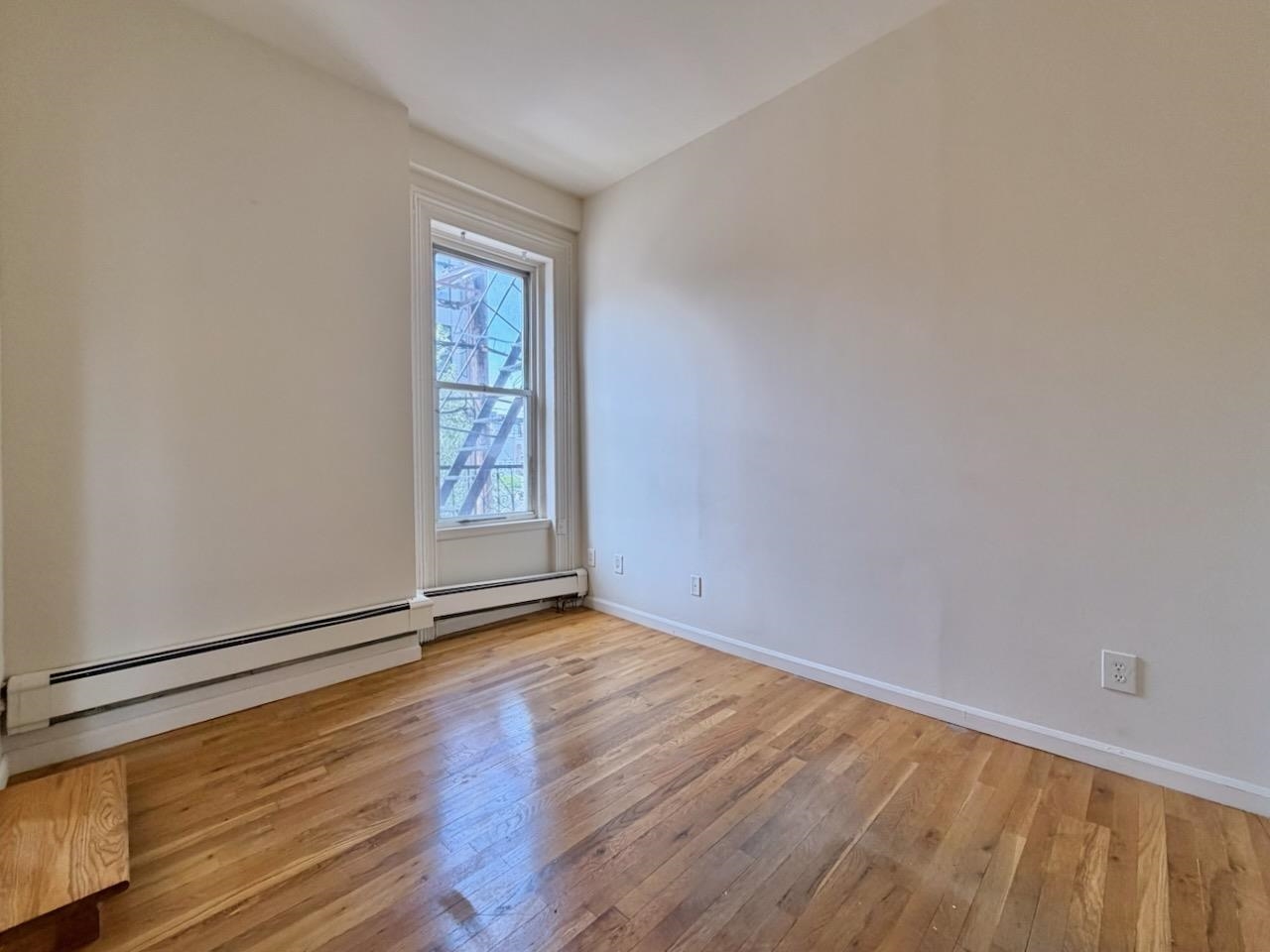 415 1st Street, Unit 2R Hoboken, NJ 07030 - Photo 8 of 22 a view of an empty room with window and wooden floor