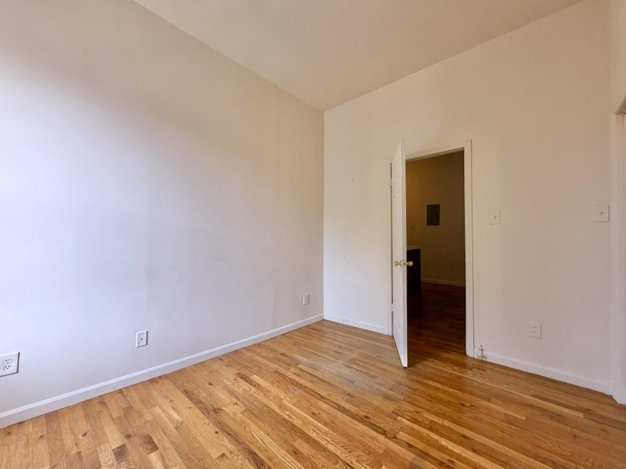 415 1st Street, Unit 2R Hoboken, NJ 07030 - Photo 9 of 22 a view of an empty room with wooden floor and closet