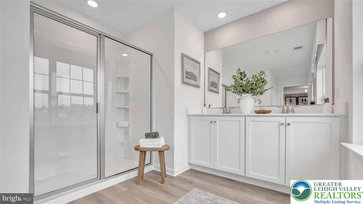 115 Winding Road Easton, PA 18040 - Photo 23 of 24 This modern bathroom offers a spacious walk-in shower and a double vanity for optimal functionality.