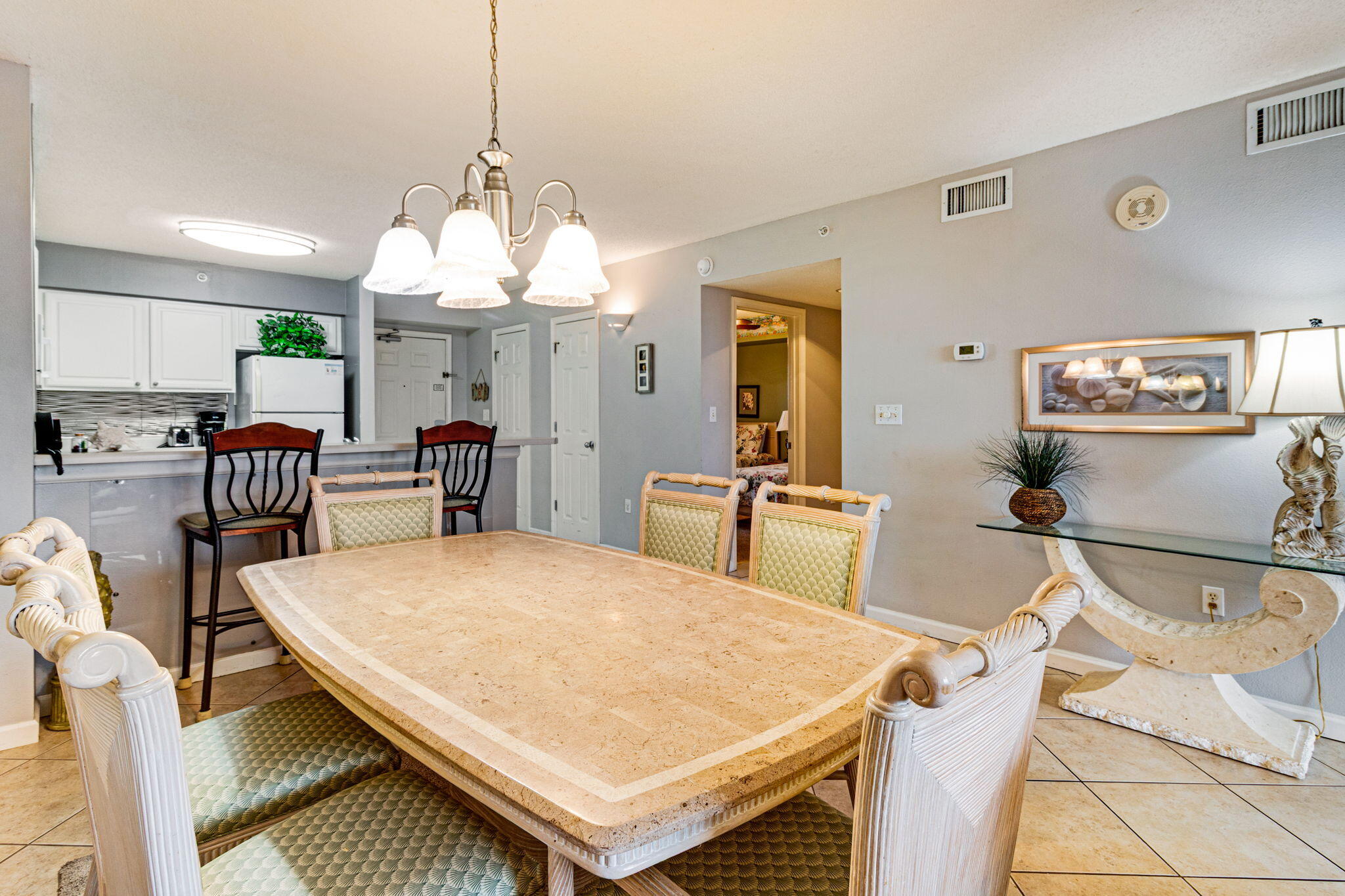 970 Highway 98, Unit 303 Destin, FL 32541 - Photo 7 of 42 a large kitchen with a table and chairs