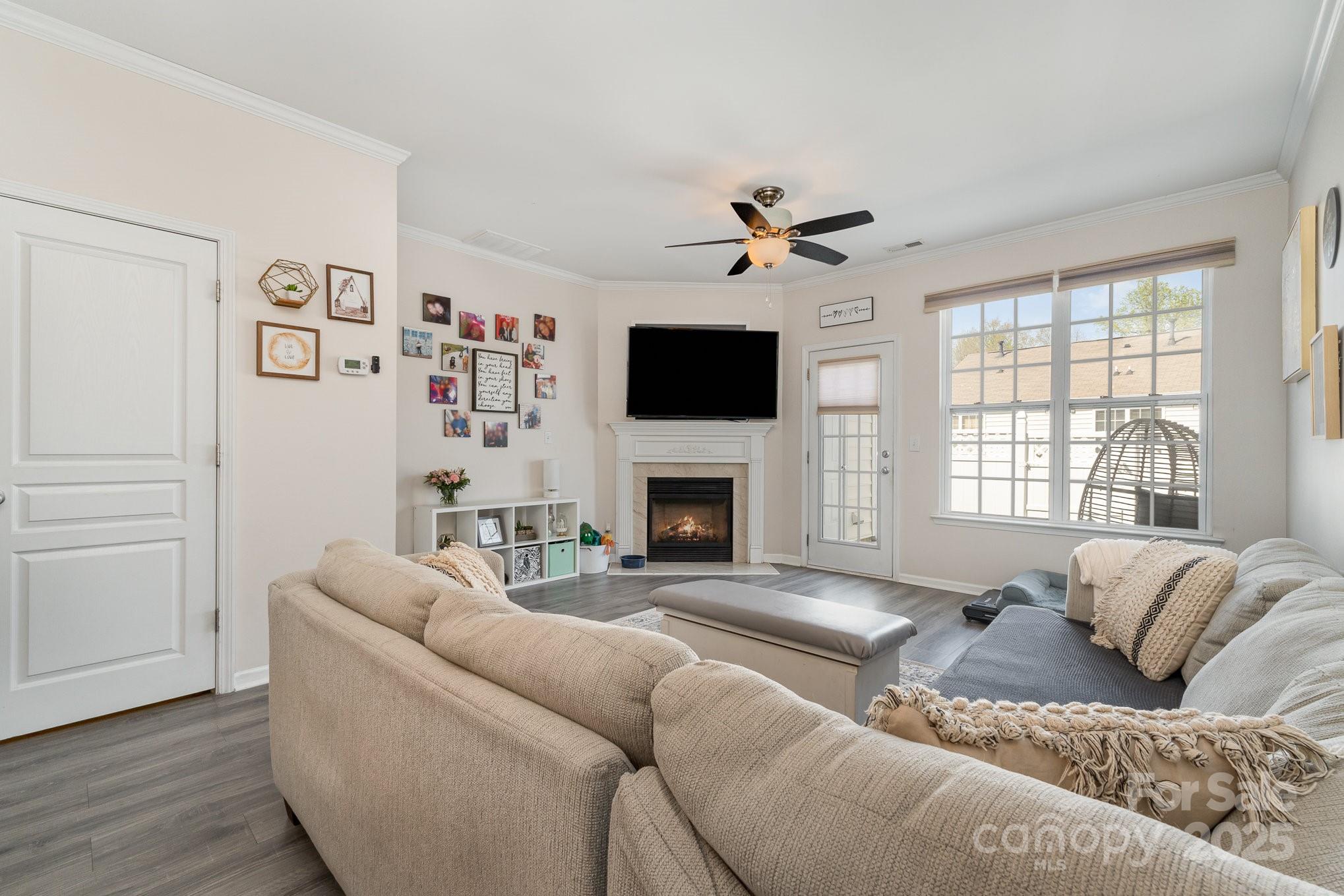 816 Gentlewinds Court Fort Mill, SC 29708 - Photo 5 of 19 a living room with furniture large window and a fireplace