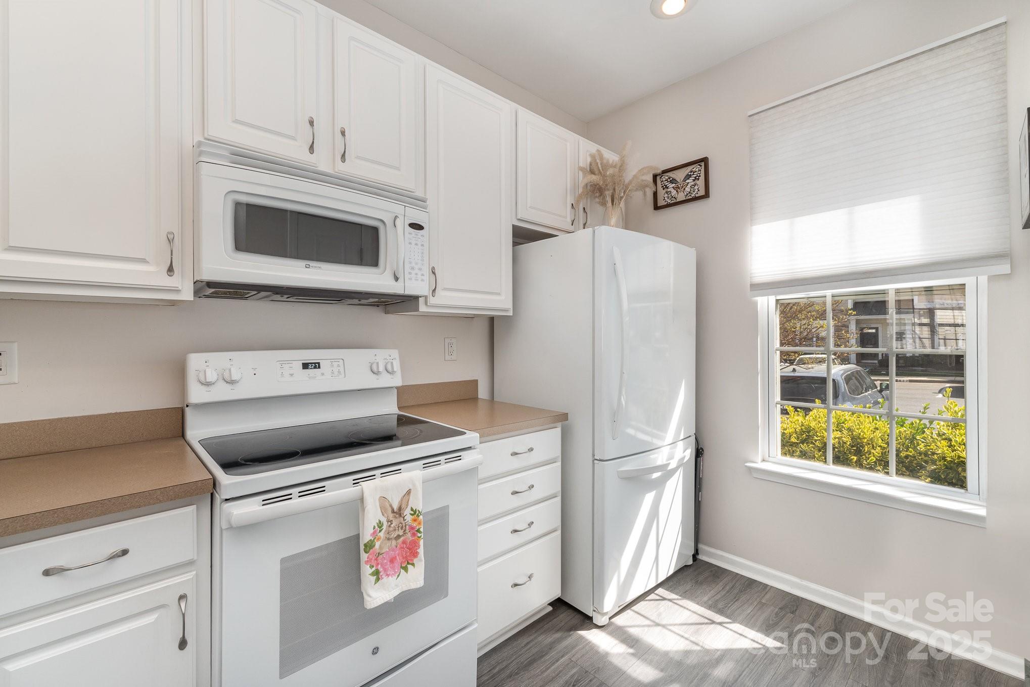 816 Gentlewinds Court Fort Mill, SC 29708 - Photo 8 of 19 a kitchen with white cabinets and white appliances