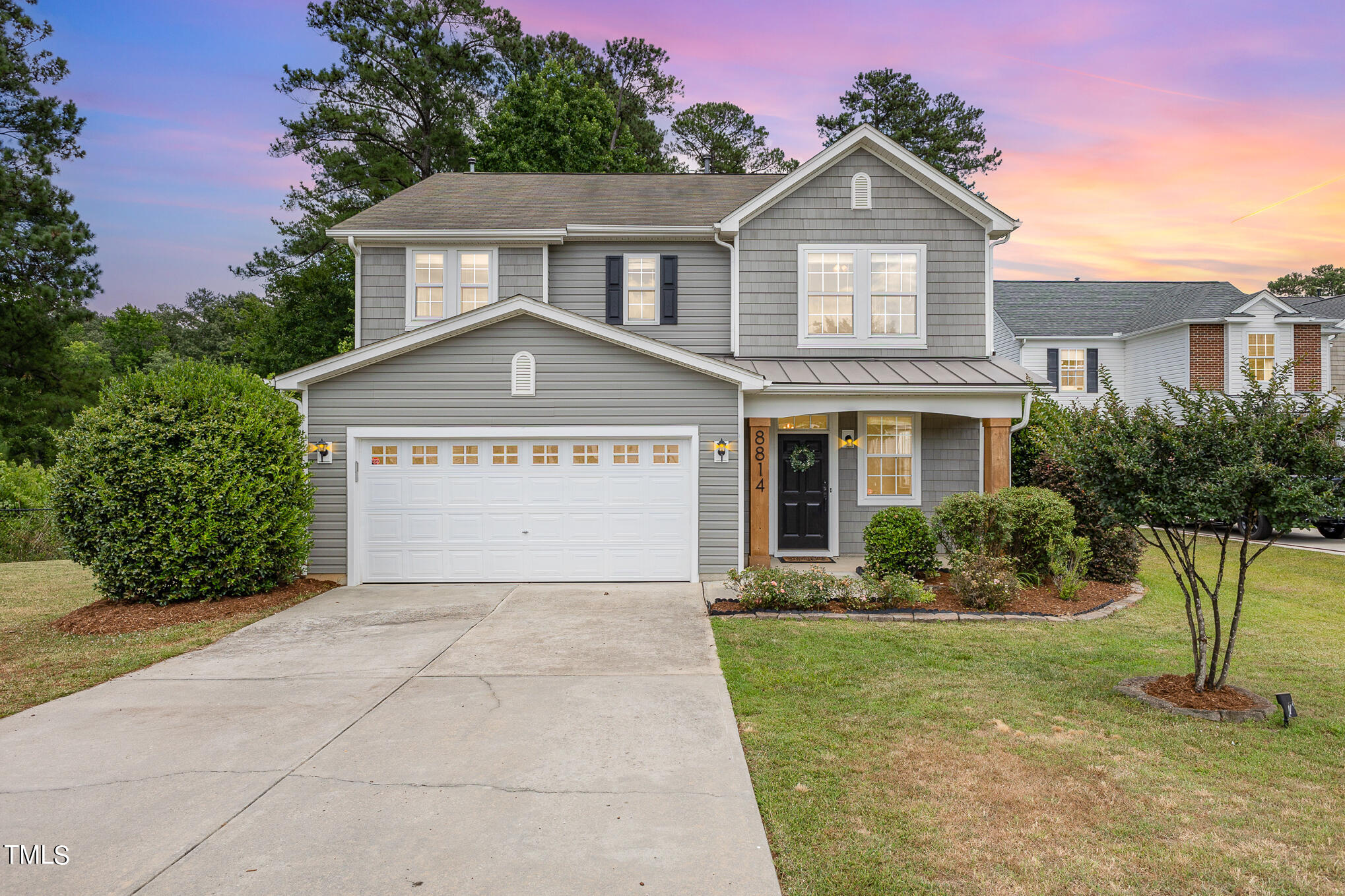 8814 Elizabeth Bennet Place Raleigh, NC 27616 - Photo 1 of 28 a front view of a house with a yard and garage