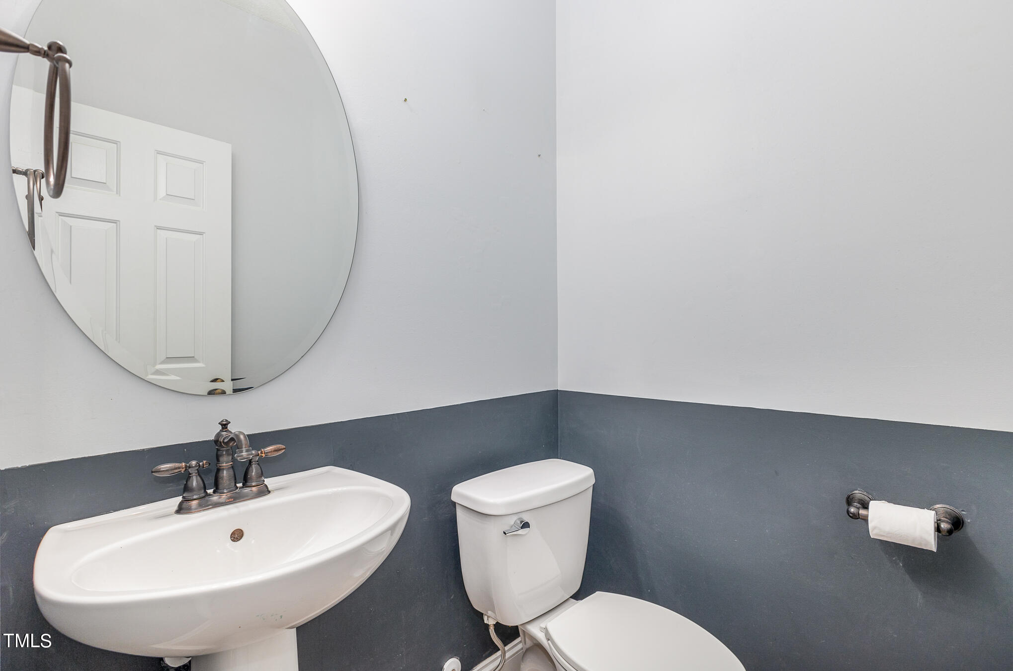 8814 Elizabeth Bennet Place Raleigh, NC 27616 - Photo 15 of 28 a bathroom with a toilet a sink and mirror