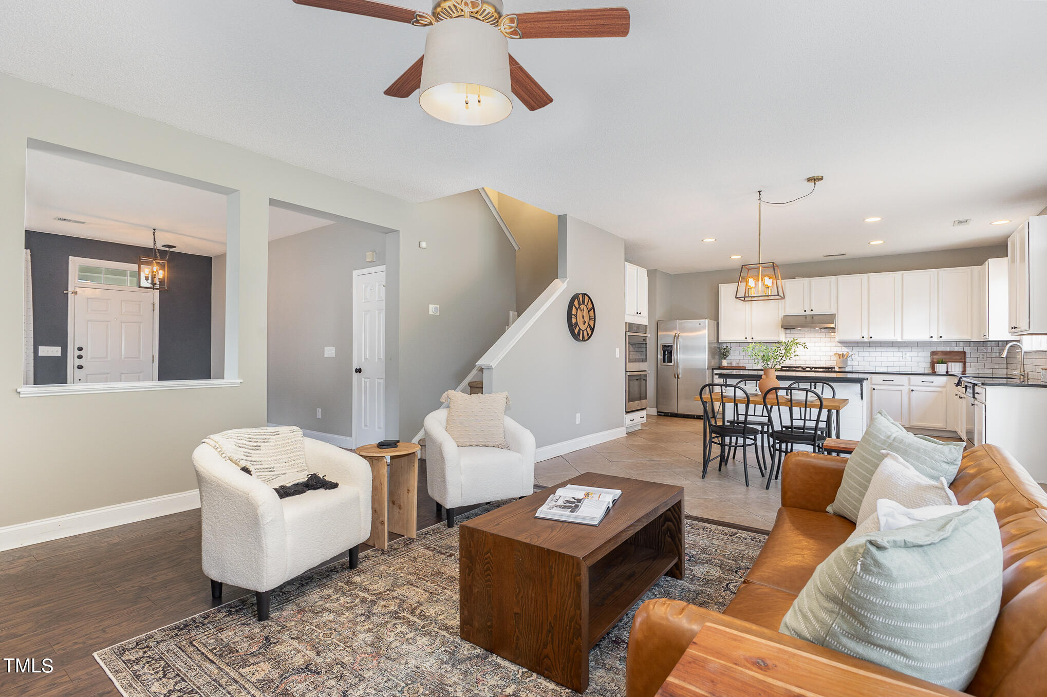 8814 Elizabeth Bennet Place Raleigh, NC 27616 - Photo 7 of 28 a living room with furniture and a wooden floor