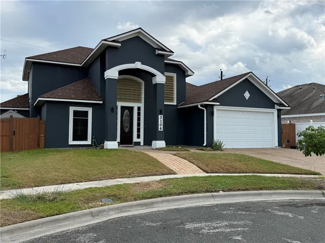 a front view of a house with a garden