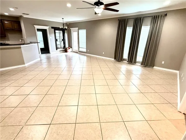 a view of a livingroom with an empty space and a window