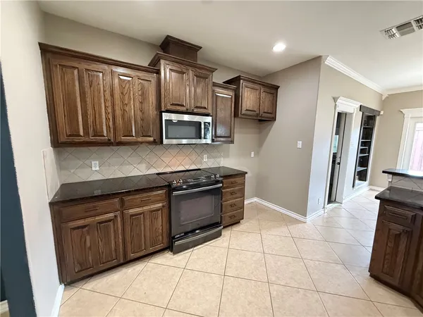 a kitchen with stainless steel appliances granite countertop a refrigerator and a sink