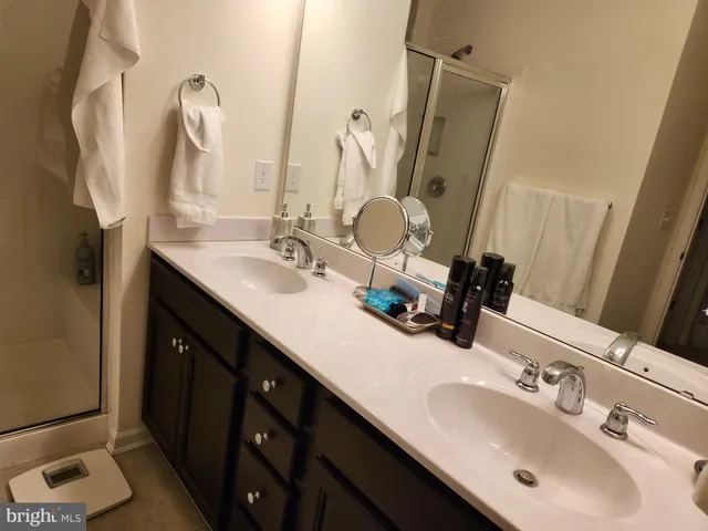 a bathroom with a double vanity sink and a mirror