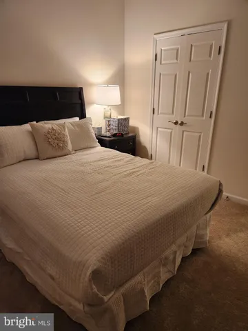 a bedroom with a bed and a mirror