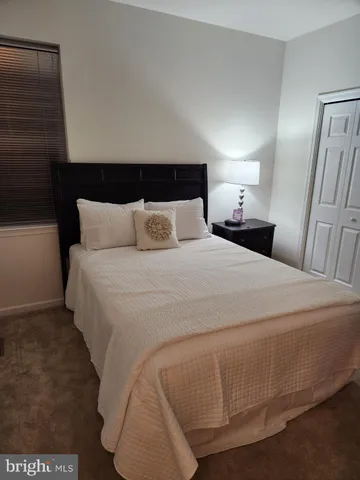 a bedroom with a bed and a mirror