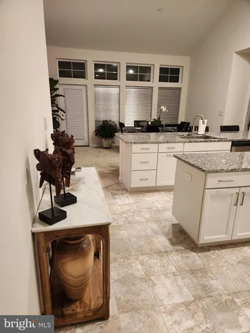 a kitchen with granite countertop a stove a sink and a microwave