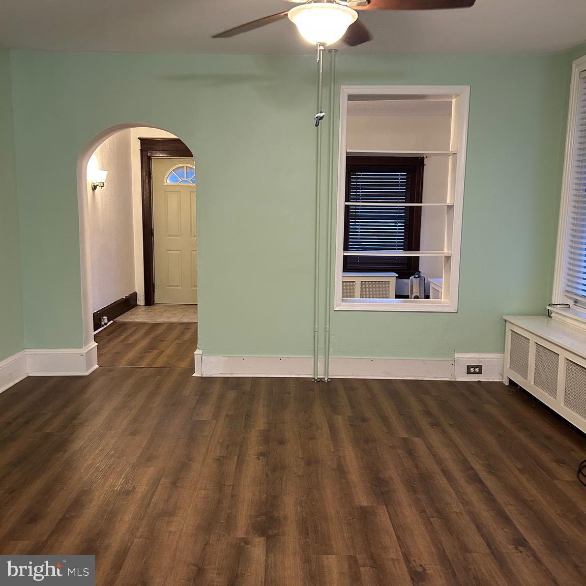 431 Broad Street Spring City, PA 19475 - Photo 12 of 42 a view of a room with wooden floor and a ceiling fan