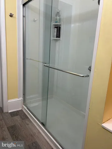 a bathroom with a granite countertop shower