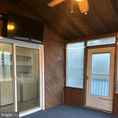 a utility room with closet and mirror