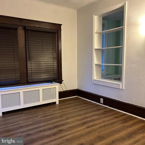 a view of a room with wooden floor and window