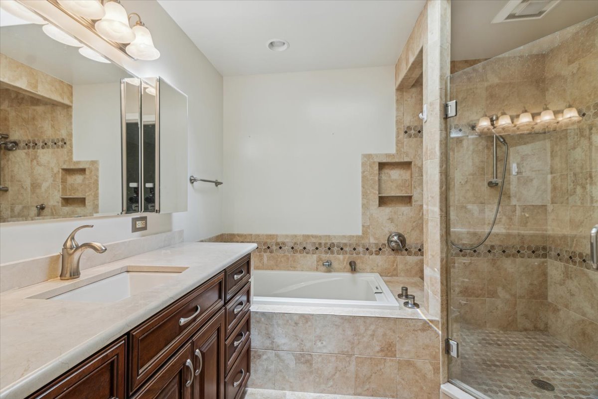 417 River Bluff Circle Naperville, IL 60540 - Photo 13 of 20 a bathroom with a tub sink shower and mirror