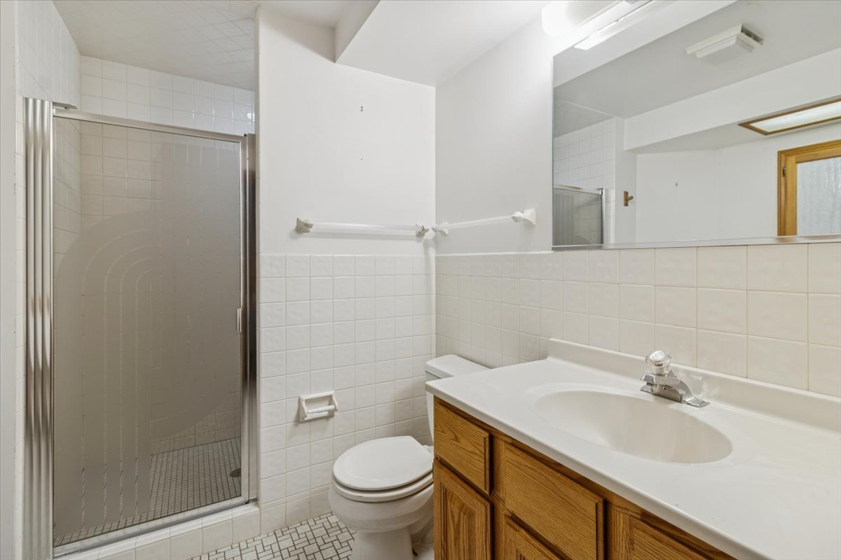417 River Bluff Circle Naperville, IL 60540 - Photo 19 of 20 a bathroom with a granite countertop sink toilet and shower
