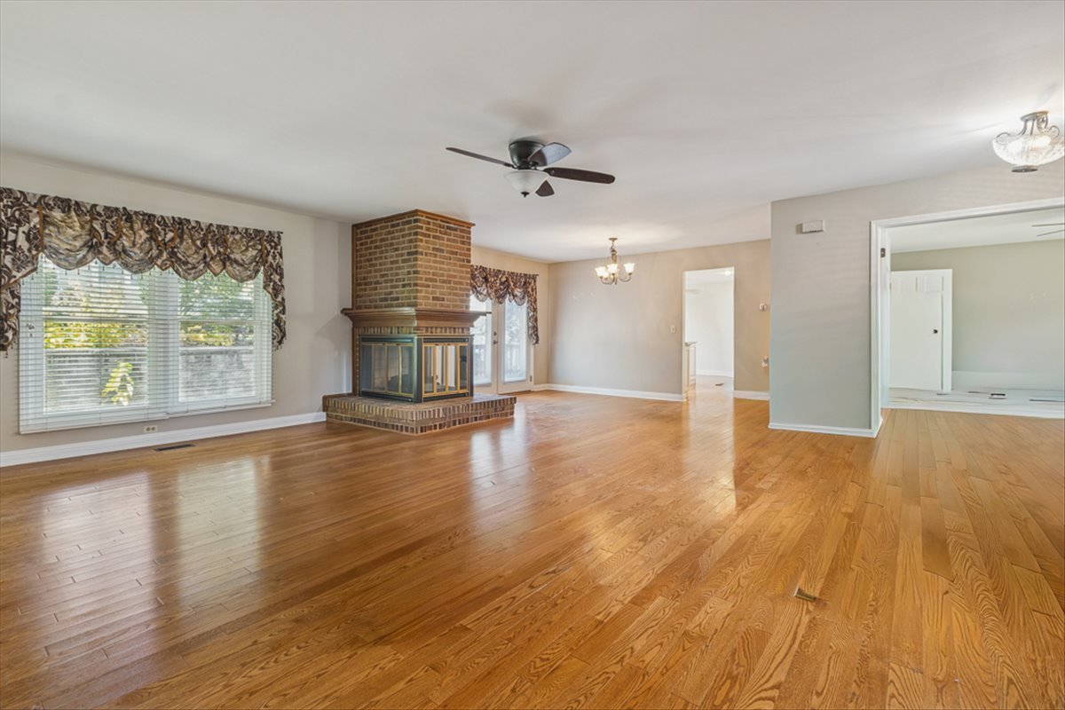 417 River Bluff Circle Naperville, IL 60540 - Photo 2 of 20 an empty room with wooden floor and windows