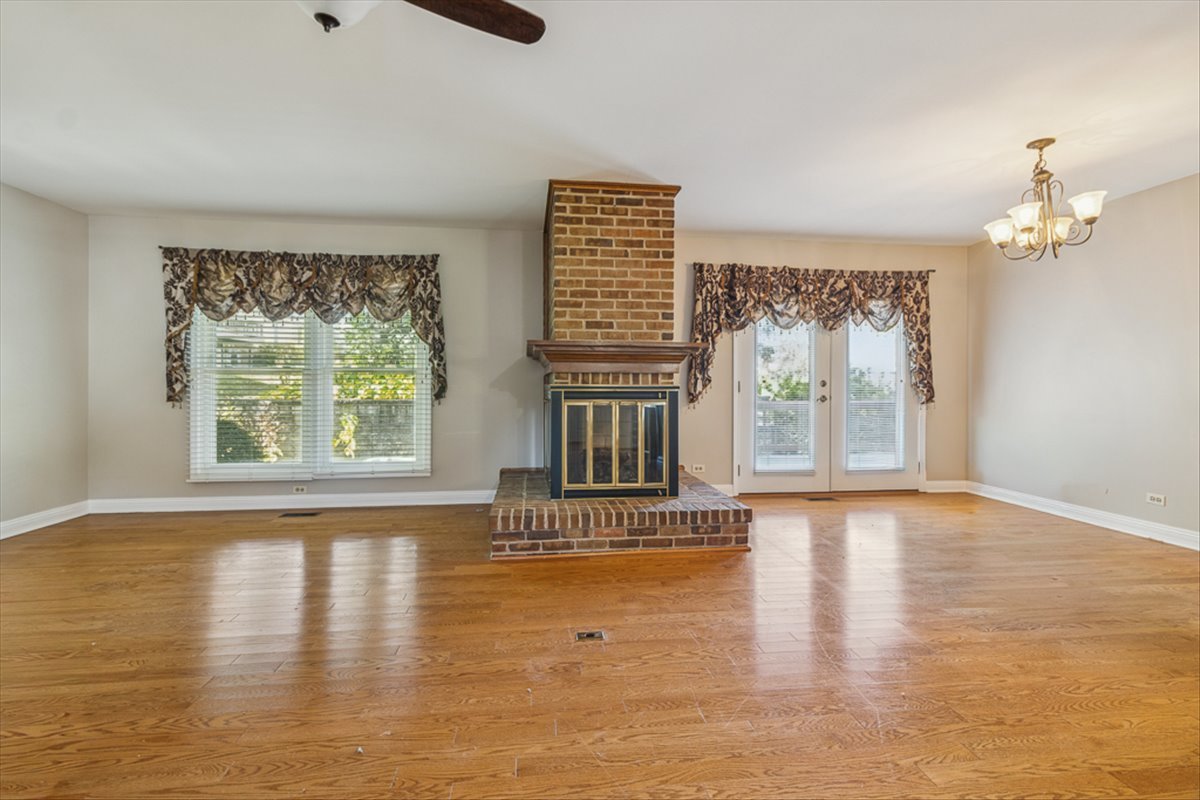 417 River Bluff Circle Naperville, IL 60540 - Photo 3 of 20 a view of an empty room with wooden floor and a window
