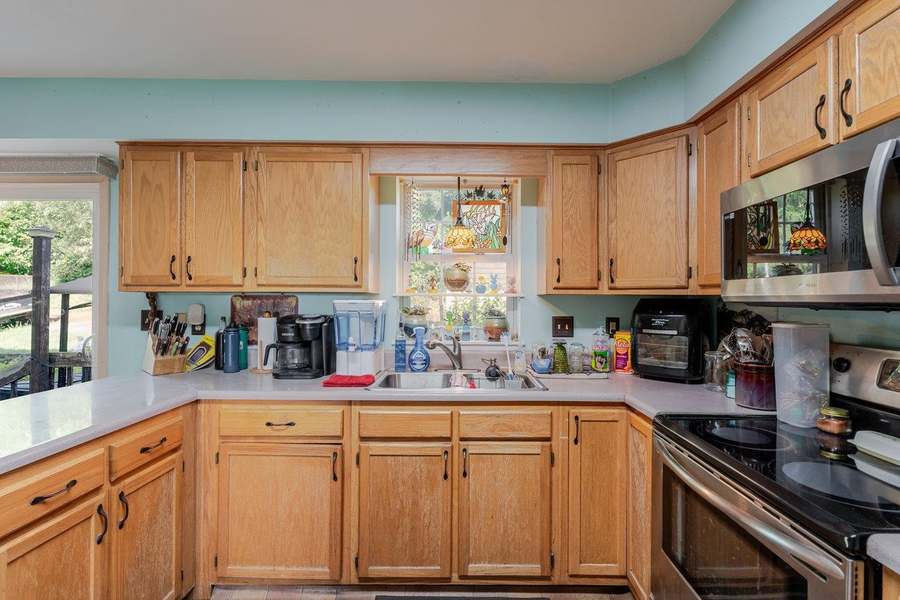 107 Orchard Road Staunton, VA 24401 - Photo 11 of 44 a kitchen with stainless steel appliances granite countertop a sink stove and cabinets