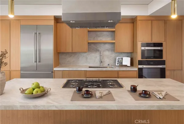 a kitchen with a refrigerator and wooden floor