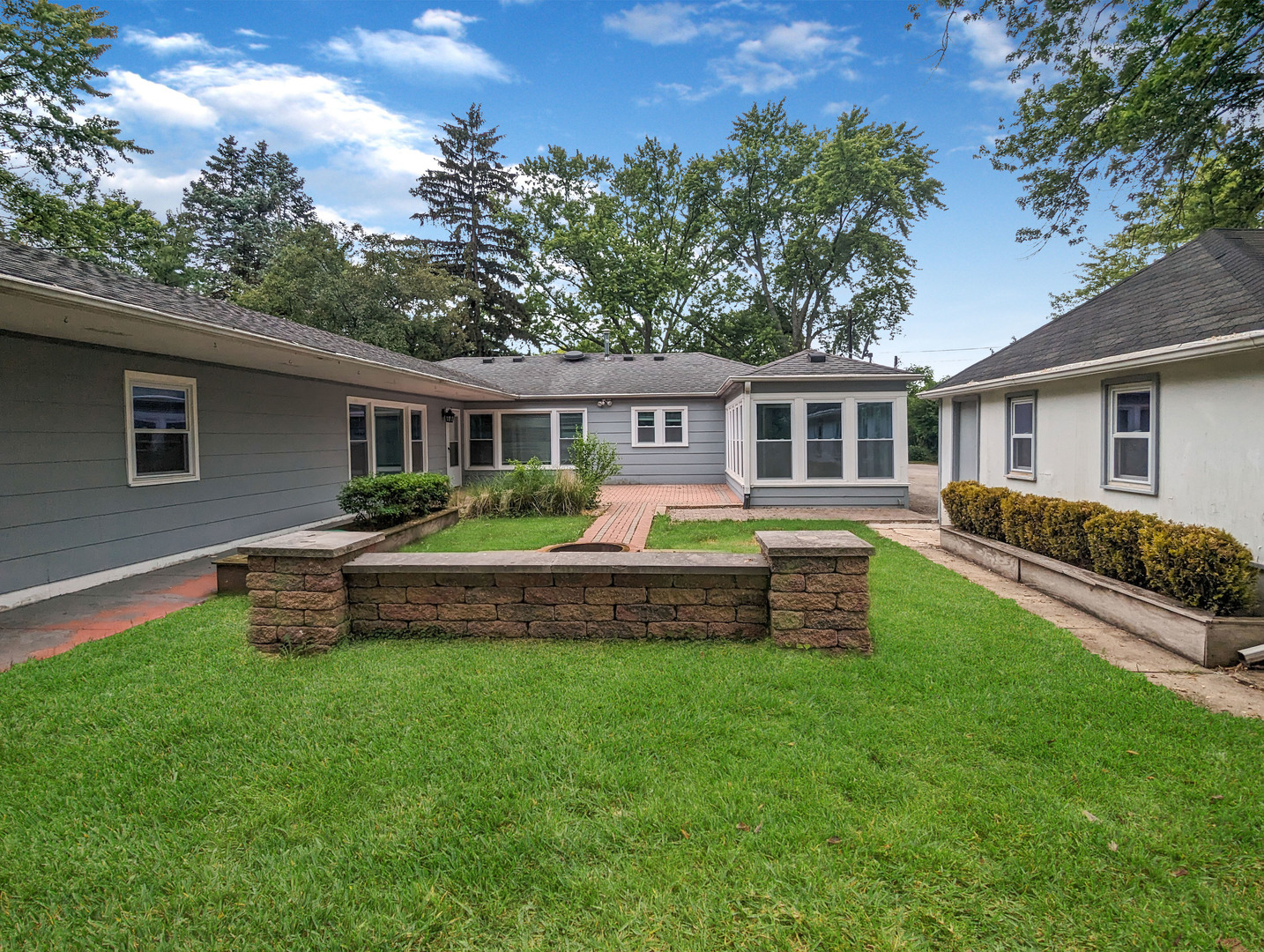 1369 North Quentin Road Palatine, IL 60067 - Photo 11 of 12 a front view of a house with a yard table and chairs