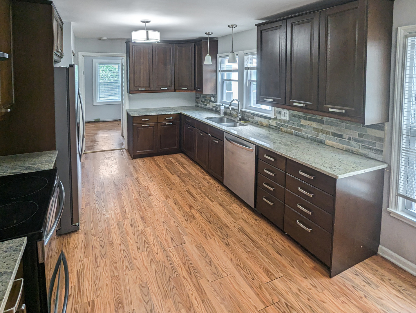 1369 North Quentin Road Palatine, IL 60067 - Photo 8 of 12 a large kitchen with wooden floor and stainless steel appliances
