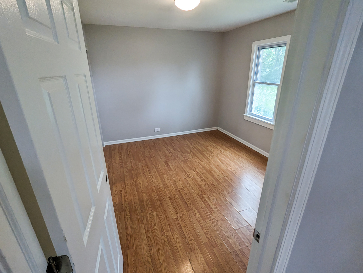 1369 North Quentin Road Palatine, IL 60067 - Photo 9 of 12 an empty room with wooden floor and windows