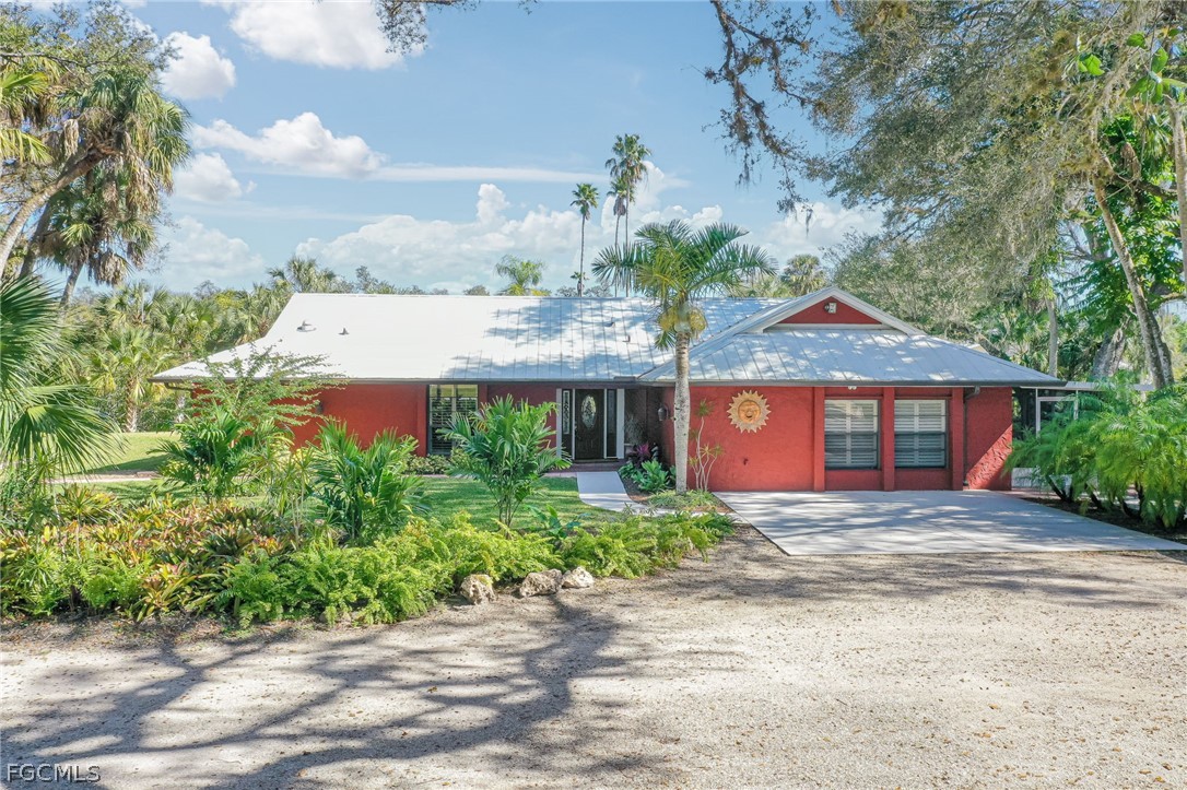 4601 Orange River Loop Road Fort Myers, FL 33905 - Photo 1 of 50 a front view of a house with garden