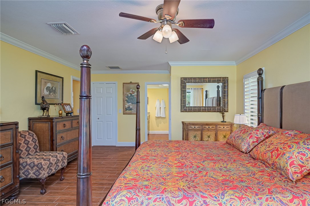 4601 Orange River Loop Road Fort Myers, FL 33905 - Photo 19 of 50 a bedroom with a bed chandelier and a window
