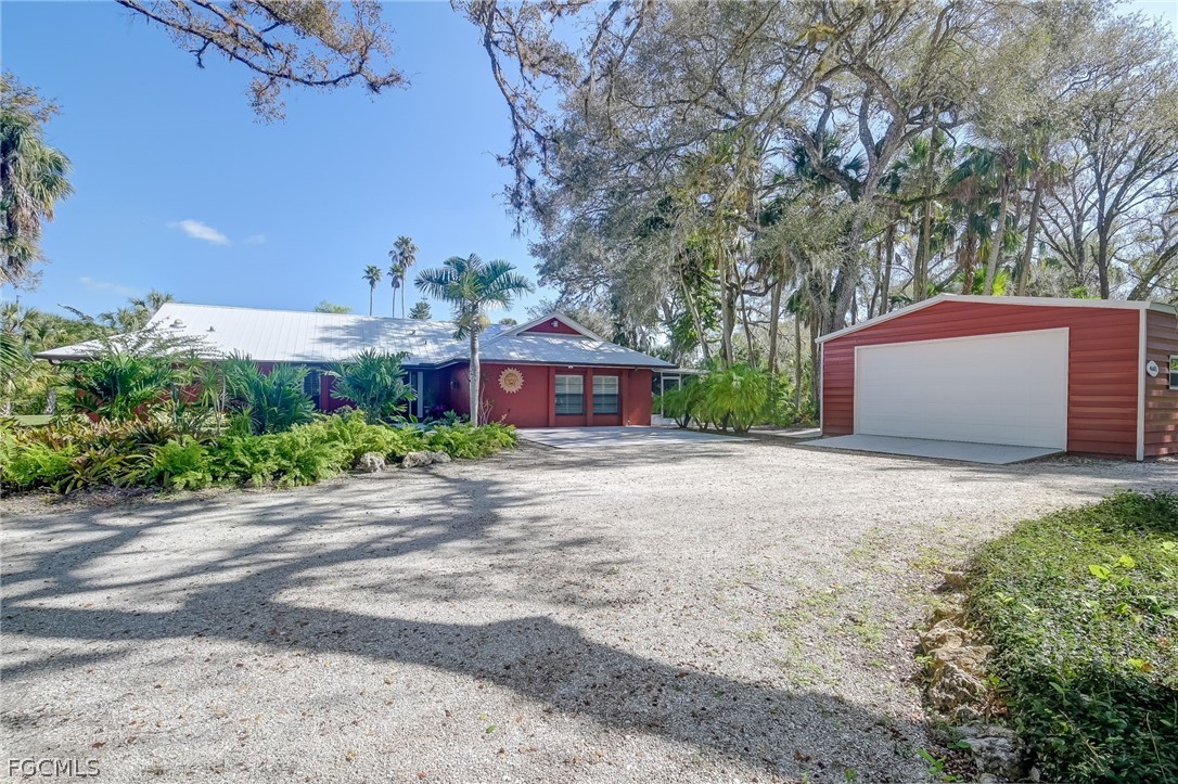 4601 Orange River Loop Road Fort Myers, FL 33905 - Photo 2 of 50 a front view of a house with a yard and garage