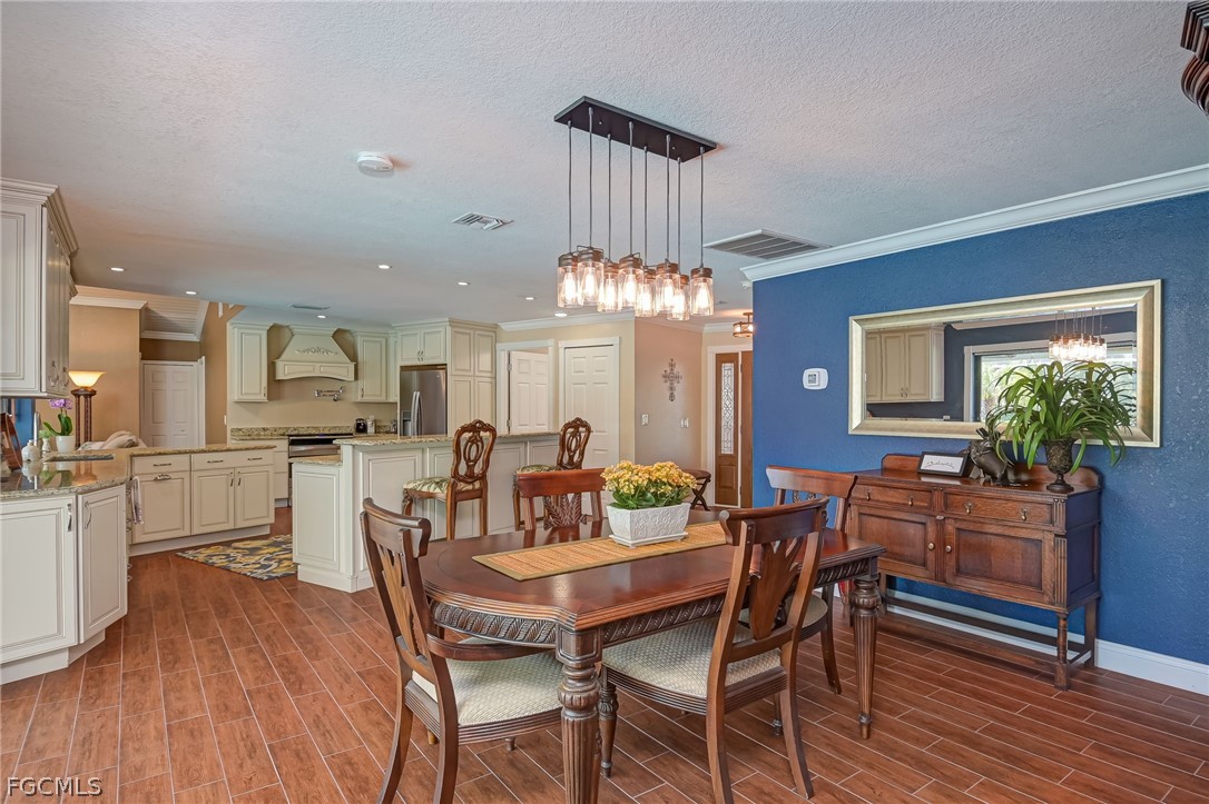 4601 Orange River Loop Road Fort Myers, FL 33905 - Photo 23 of 50 a view of a dining room with furniture and wooden floor