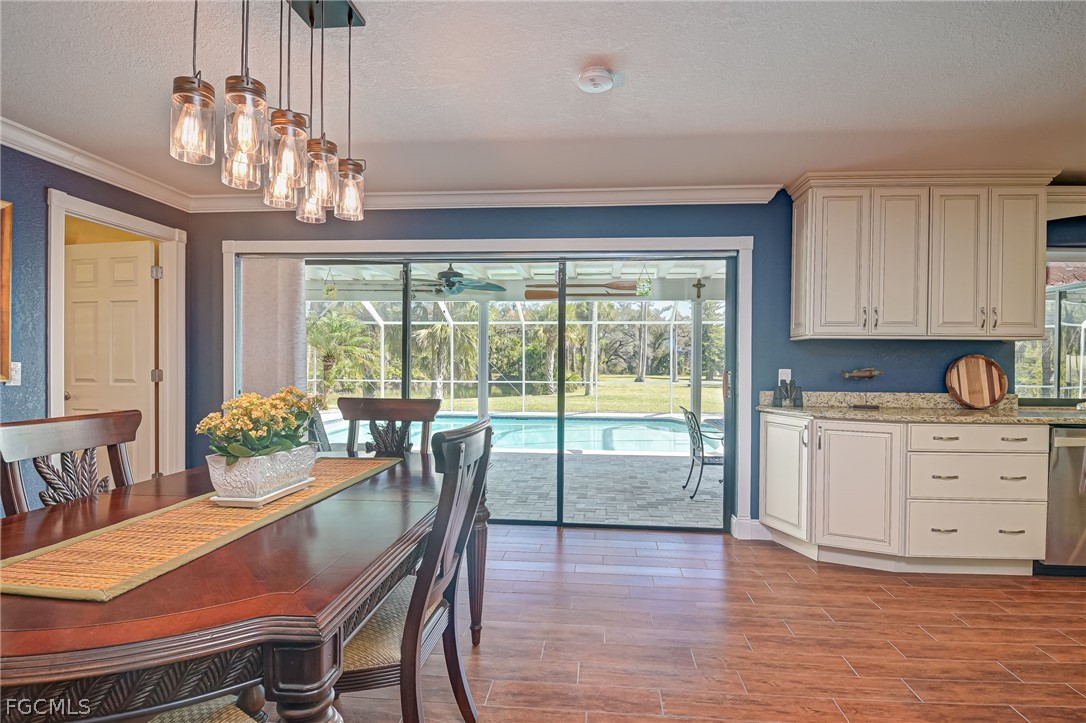 4601 Orange River Loop Road Fort Myers, FL 33905 - Photo 25 of 50 a view of a dining room with furniture a chandelier and wooden floor