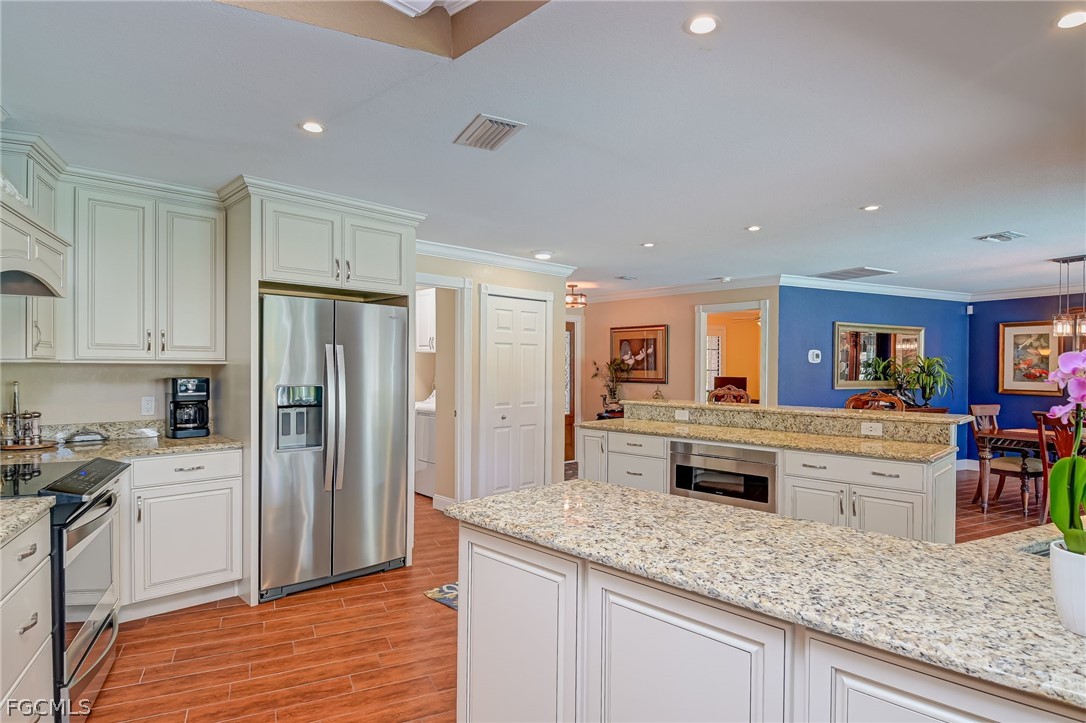 4601 Orange River Loop Road Fort Myers, FL 33905 - Photo 26 of 50 a kitchen with stainless steel appliances granite countertop a refrigerator and a sink