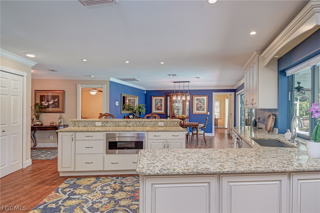 4601 Orange River Loop Road Fort Myers, FL 33905 - Photo 27 of 50 a kitchen with granite countertop a stove and cabinets