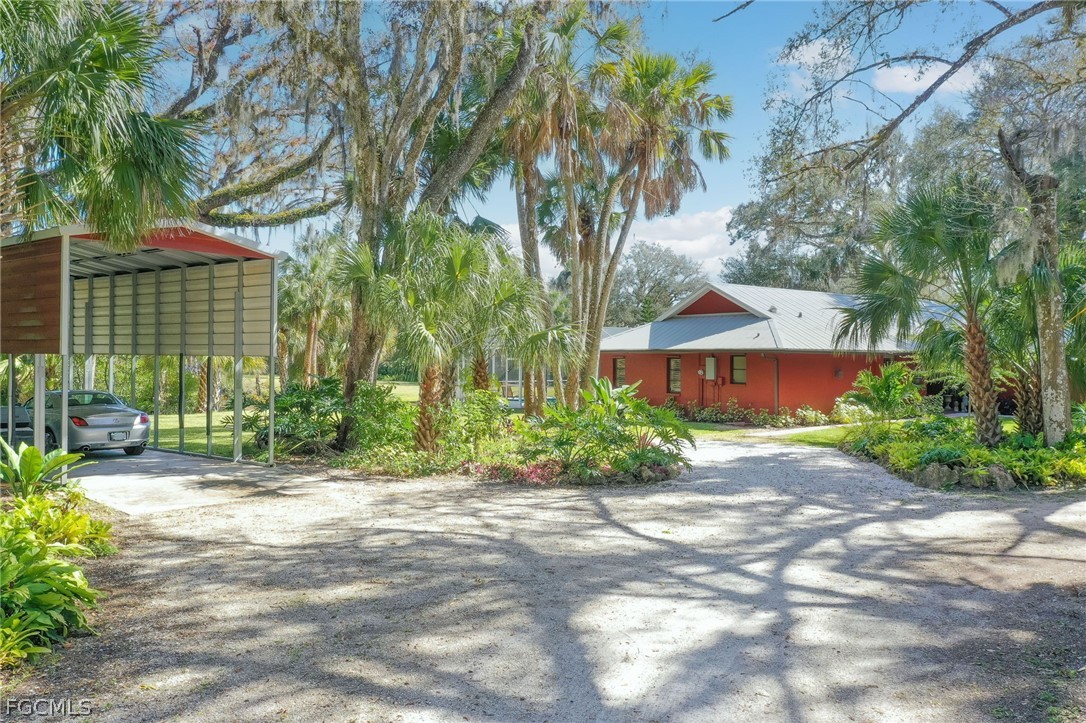 4601 Orange River Loop Road Fort Myers, FL 33905 - Photo 3 of 50 a front view of a house with a yard and outdoor seating