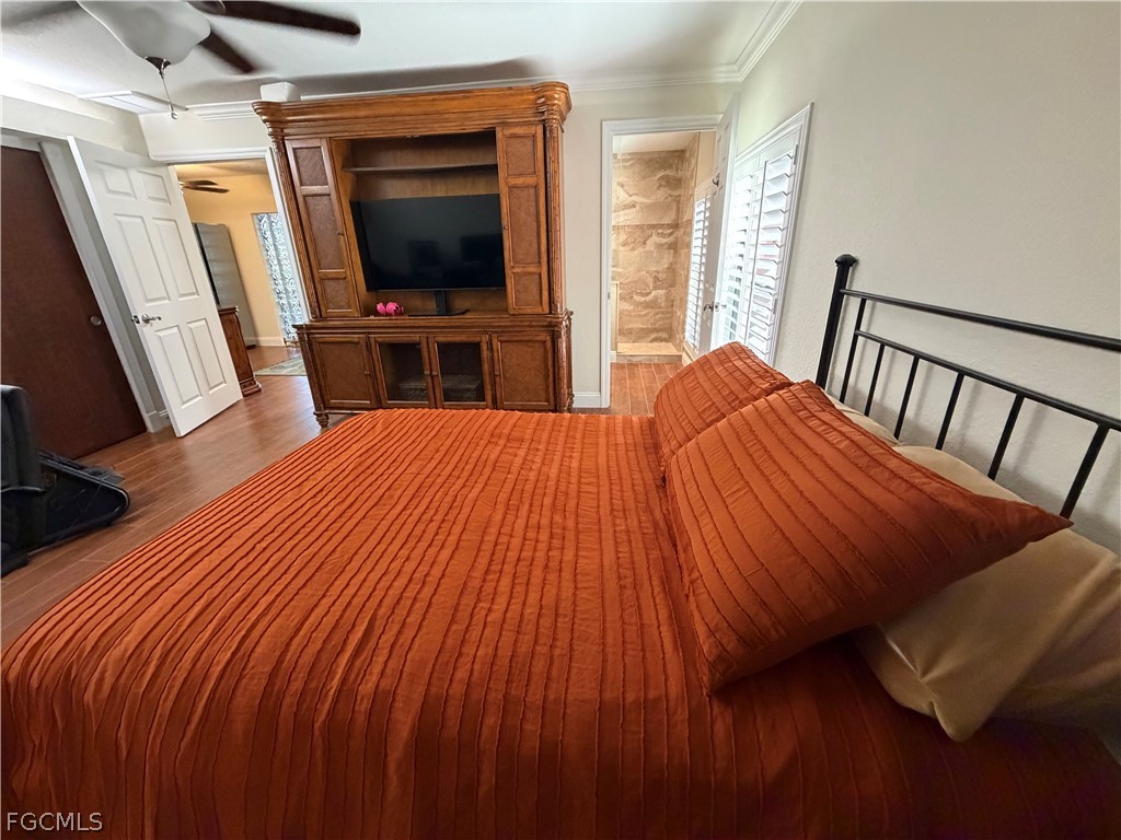 4601 Orange River Loop Road Fort Myers, FL 33905 - Photo 42 of 50 a bedroom with a bed and a flat tv screen on dresser