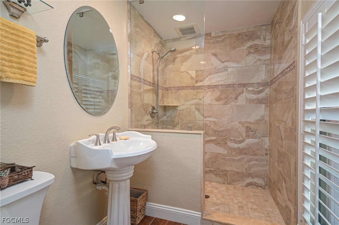 4601 Orange River Loop Road Fort Myers, FL 33905 - Photo 43 of 50 a bathroom with a sink a mirror and a shower