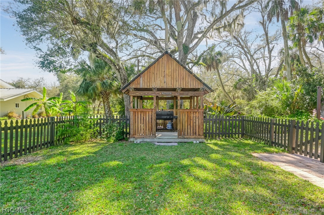 4601 Orange River Loop Road Fort Myers, FL 33905 - Photo 45 of 50 a view of a house with a yard and large trees
