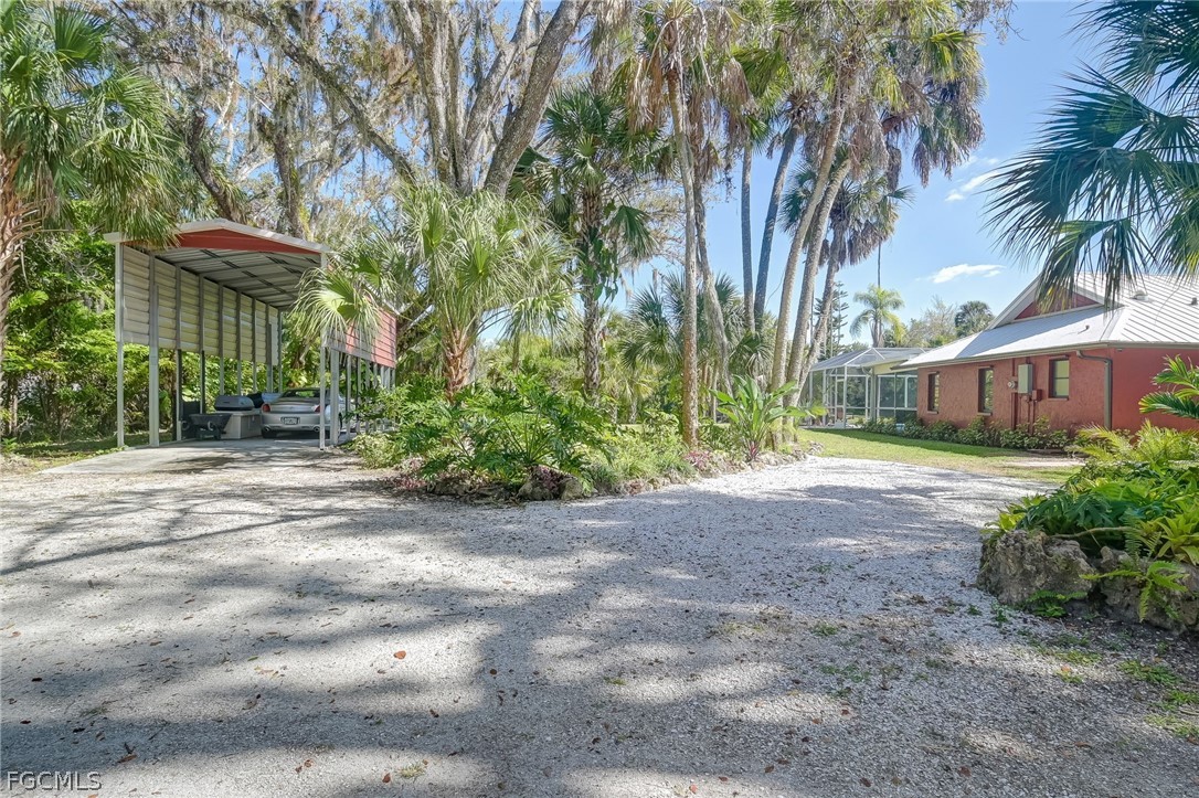 4601 Orange River Loop Road Fort Myers, FL 33905 - Photo 9 of 50 a couple of palm trees in front of house