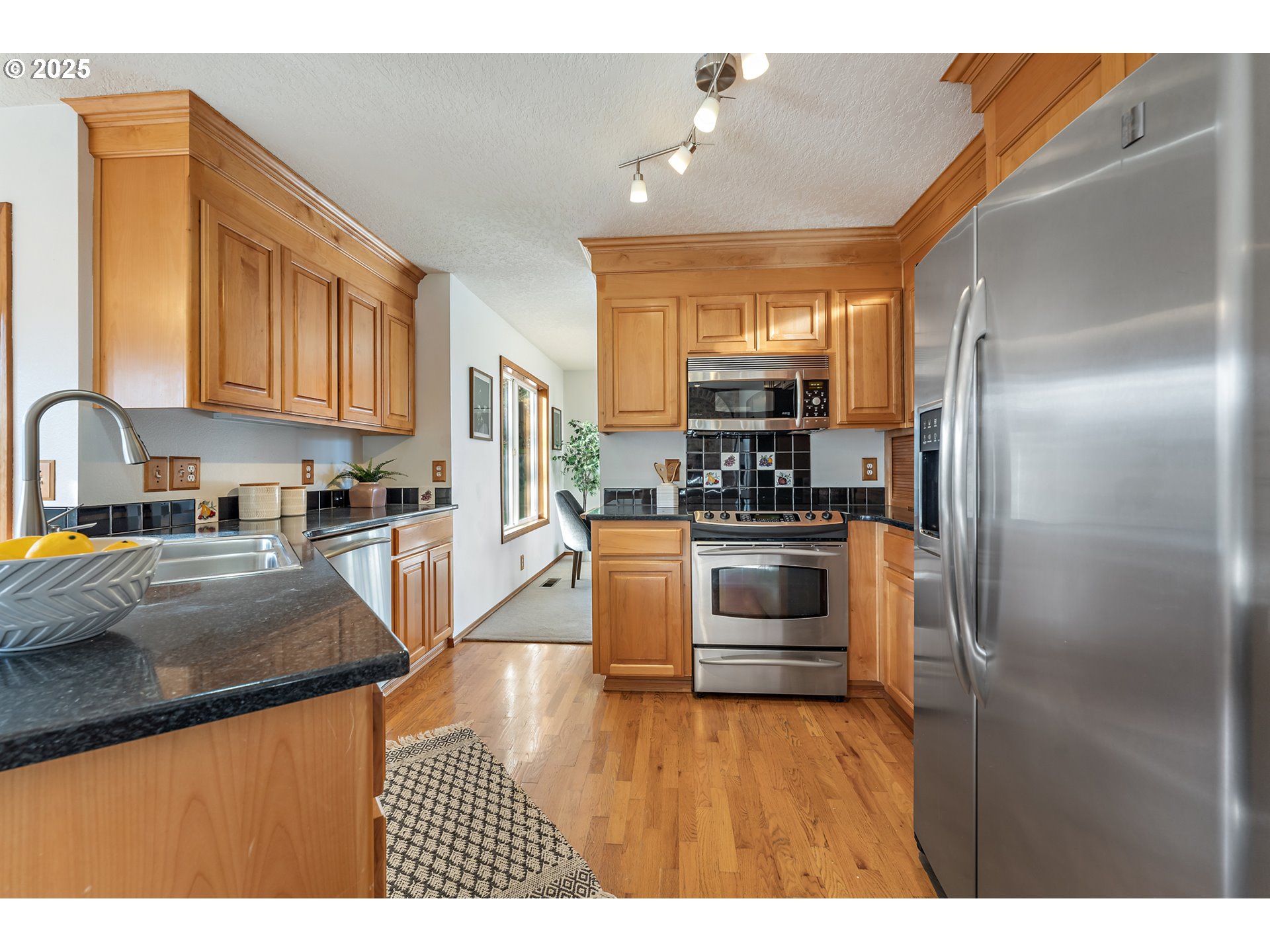 20259 Southwest Celebrity Street Beaverton, OR 97078 - Photo 11 of 40 a kitchen with a refrigerator and a sink